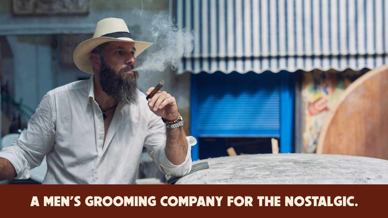 Bearded man with cigar representing a nostalgic men’s grooming brand inspired by classic American style