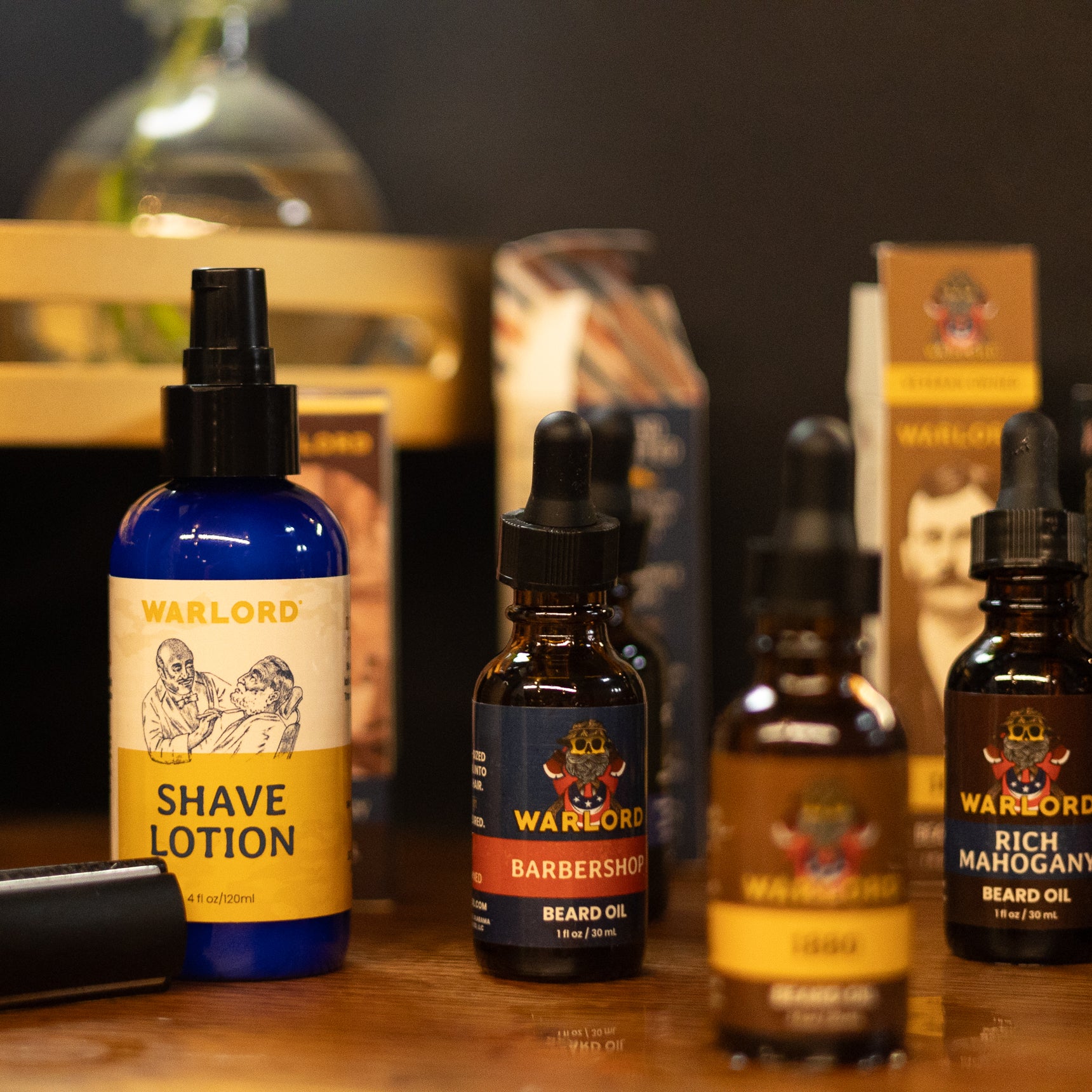 Warlord Shaving Lotion and Warlord Beard Oils displayed on a vintage countertop alongside an old-fashioned double-edge safety razor.